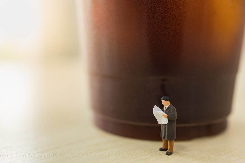 a figurine of a man reading the newspaper
